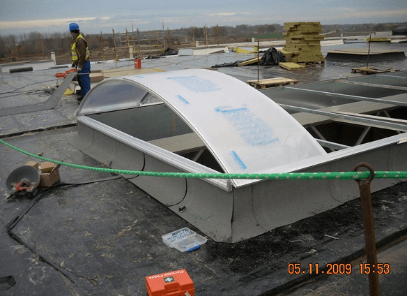 Worker installing roof skylight